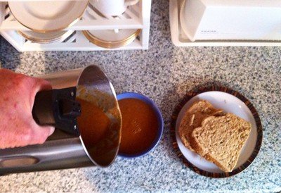 A hand filling the bowl with food