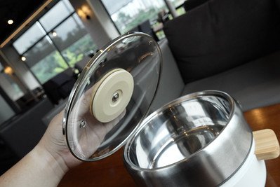 Hand holding the cover of a kitchen appliance