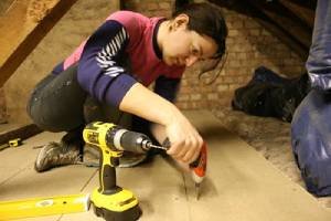 a woman fixing bolts