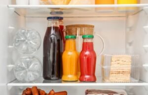bottles with juice stored in fridge