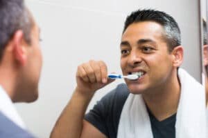 man brushing teeth