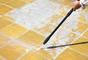 man hand cleaning outdoor driveway