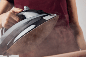 man steaming clothes