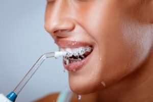 woman practicing oral hygiene with tooth cleaning tool