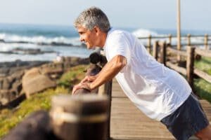 a senior working out at the beach