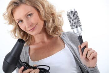 a woman holding a hair dryer