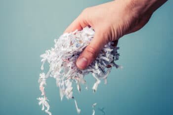 hand holding shreded documents