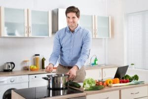 man cooking food in the kitchen