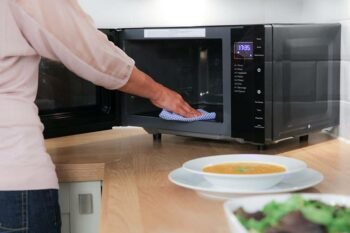 woman cleaning cooking appliance