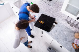 workman installing a modern cooker
