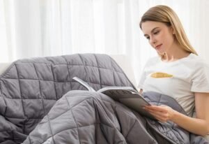 young woman sits comfortably while reading