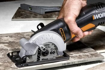 man cutting tile with power tool