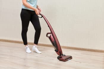 woman vacuuming the dust of te floor