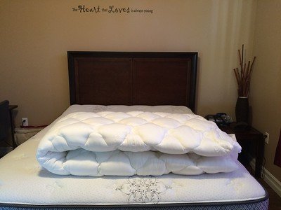 a-queen-sized-bed-with-a-large-duvet-on-it