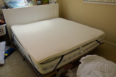 a-small-carpeted-bedroom-with-a-large-bed
