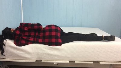 a-woman-wearing-a-plaid-jacket-sleeping-soundly-on-her-bed