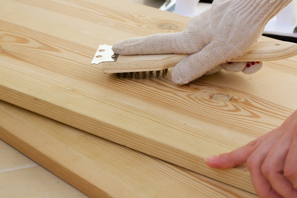 Polishing the wooden piece using a brush