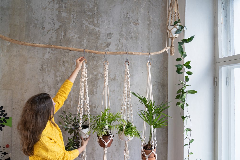 Woman gardener holding macrame plant hanger