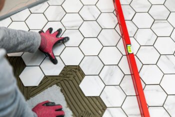 a DIY worker installing hexagon marble