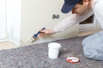 a painter painting moist wall